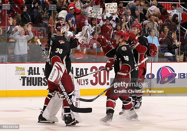 Goaltender Ilya Bryzgalov of the Phoenix Coyotes celebrates with teammates Shane Doan and Martin Hanzal after defeating the Edmonton Oilers in the...