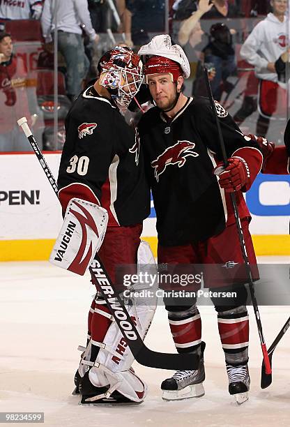 Goaltender Ilya Bryzgalov of the Phoenix Coyotes is congratulated by teammate Derek Morris after defeating the Edmonton Oilers in the NHL game at...