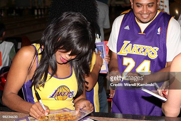 The Laker Girls sign autographs for a fan during the HOLA Bowla event held at Pinz Bowling Center on April 3, 2010 in Studio City, California. NOTE...