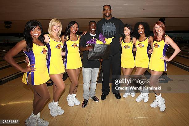 Josh Powell of the Los Angeles Lakers and the Laker Girls pose for a photo with the winner of the raffle during the HOLA Bowla event on April 3, 2010...