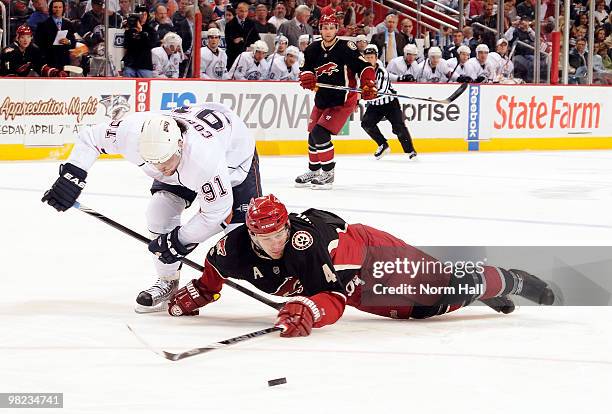 Zbynek Michalek of the Phoenix Coyotes and Mike Comrie of the Edmonton Oilers go after the puck on April 3, 2010 at Jobing.com Arena in Glendale,...