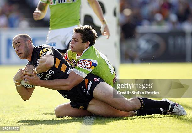 Liam Fulton of the Tigers scores a try during the round four NRL match between the Canberra Raiders and the West Tigers at Canberra Stadium on April...