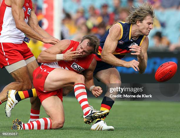 Trent Hentschel of the Crows and Jude Bolton of the Swans collides with each other during the round two AFL match between the Adelaide Crows and the...