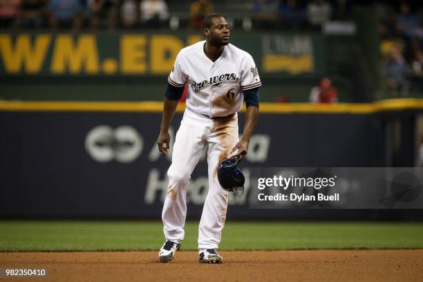 Lorenzo Cain of the Milwaukee Brewers retrieves his helmet after stealing second base in the fourth inning against the St. Louis Cardinals at Miller...