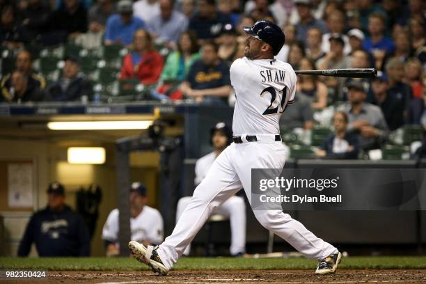 Travis Shaw of the Milwaukee Brewers his a sacrifice fly in the fourth inning against the St. Louis Cardinals at Miller Park on June 21, 2018 in...