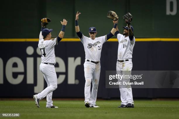 Hernan Perez, Christian Yelich, and Domingo Santana of the Milwaukee Brewers celebrate after beating the St. Louis Cardinals 11-3 at Miller Park on...