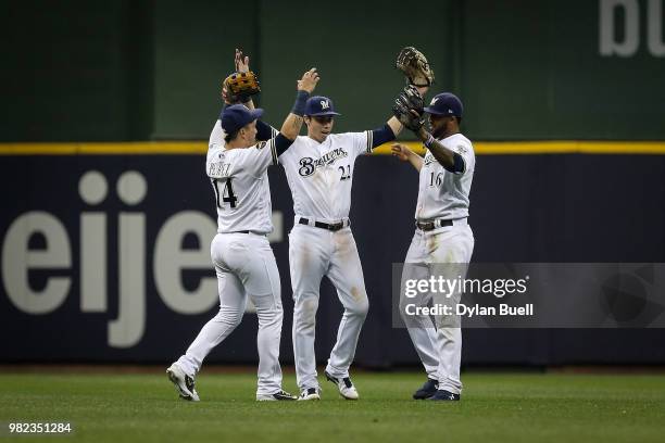 Hernan Perez, Christian Yelich, and Domingo Santana of the Milwaukee Brewers celebrate after beating the St. Louis Cardinals 11-3 at Miller Park on...