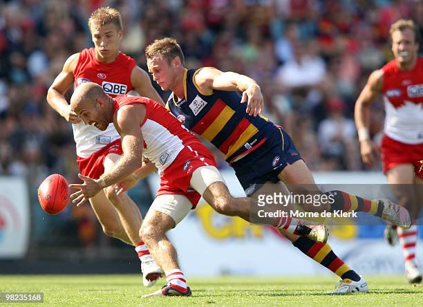 Brent Reilly of the Crows tackles Jarrad McVeigh of the Swans during the round two AFL match between the Adelaide Crows and the Sydney Swans at AAMI...
