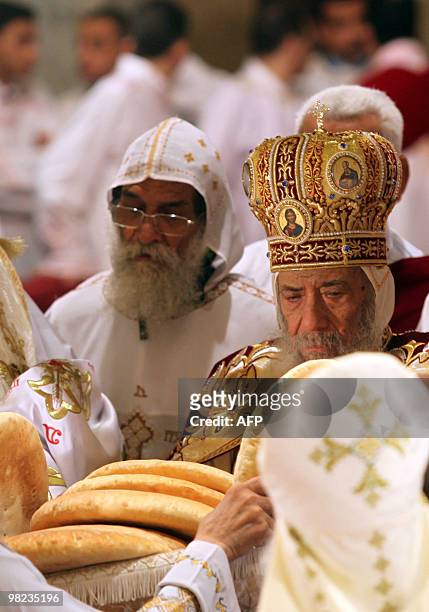 Pope Shenuda III blesses bread to be handed out to worshippers during Coptic Easter mass at Cairo's Abbassiya Cathedral in the early hours of April...