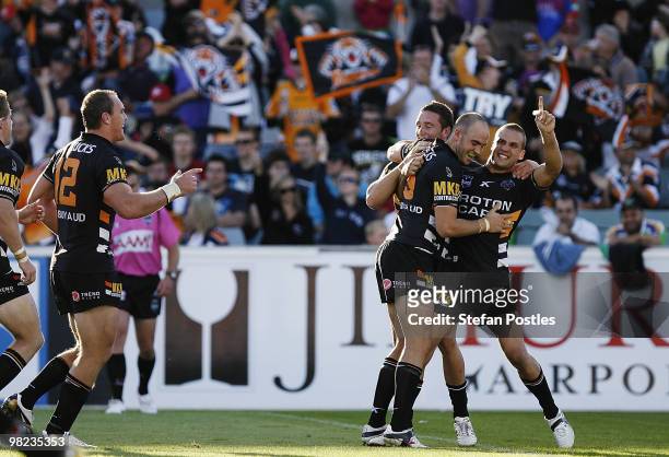Tigers players celebrate after Liam Fulton scored a try during the round four NRL match between the Canberra Raiders and the West Tigers at Canberra...
