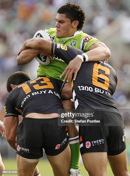Daniel Vidot of the Raiders is tackled by Chris Heighington and Benji Marshall of the Tigers during the round four NRL match between the Canberra...