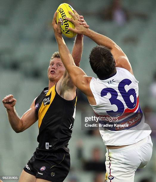 Chris Newman of the Tigers and Brian Lake of the Bulldogs compete for the ball during the round two AFL match between the Richmond Tigers and the...