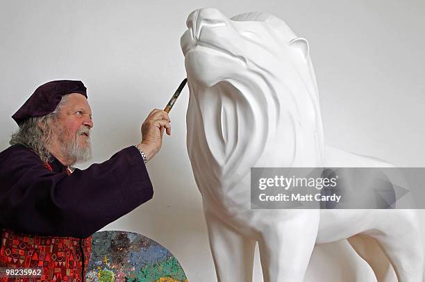 Lord Bath begins to paint a lion given to him by the Lions of Bath public art project to decorate in his studio at Longleat House on April 1, 2010...