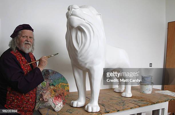 Lord Bath begins to paint a lion given to him by the Lions of Bath public art project to decorate in his studio at Longleat House on April 1, 2010...