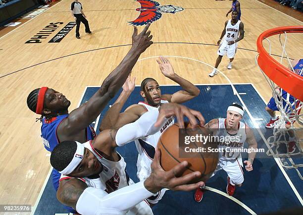 Josh Smith of the Atlanta Hawks grabs a rebound against Kwame Brown of the Detroit Pistons on April 3, 2010 at Philips Arena in Atlanta, Georgia....