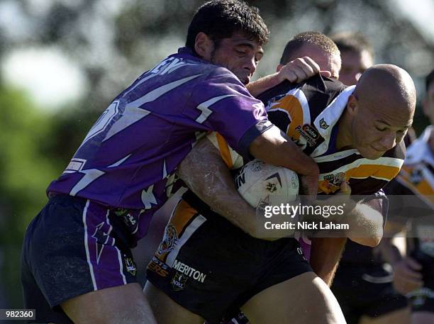 Tyran Smith of the West Tigers is tackled by Stephen Kearney of the Melbourne Storm during the Round 5 NRL Match between the West Tigers and the...