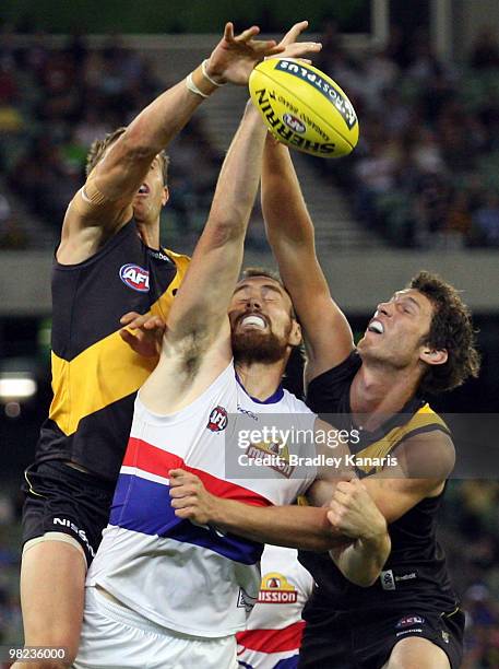 Ben Hudson of the Bulldogs is pressured by the defence during the round two AFL match between the Richmond Tigers and the Western Bulldogs at...