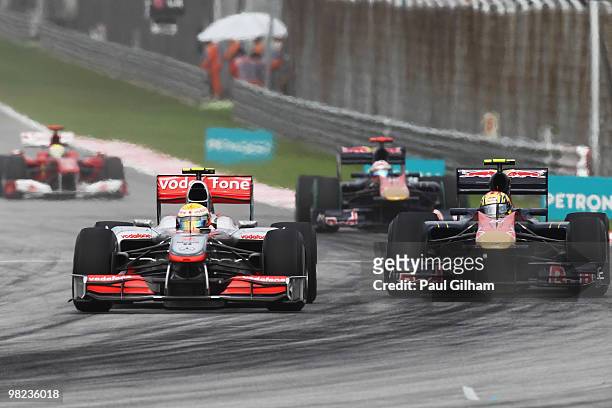 Lewis Hamilton of Great Britain and McLaren Mercedes overtakes Jaime Alguersuari of Spain and Scuderia Toro Rosso during the Malaysian Formula One...