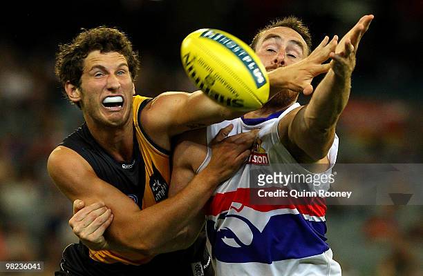 Tyrone Vickery of the Tigers and Ben Hudson of the Bulldogs contest for the ball during the round two AFL match between the Richmond Tigers and the...