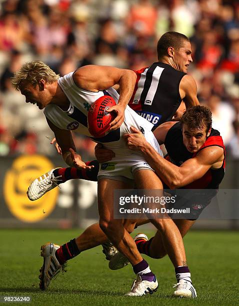 Paul Duffield of the Dockers is tackled by Jobe Watson of the Bombers during the round two AFL match between the Essendon Bombers and the Fremantle...