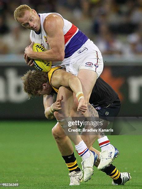 Daniel Connors of the Tigers and Adam Cooney of the Bulldogs collide during the round two AFL match between the Richmond Tigers and the Western...