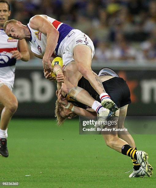 Daniel Connors of the Tigers and Adam Cooney of the Bulldogs collide during the round two AFL match between the Richmond Tigers and the Western...