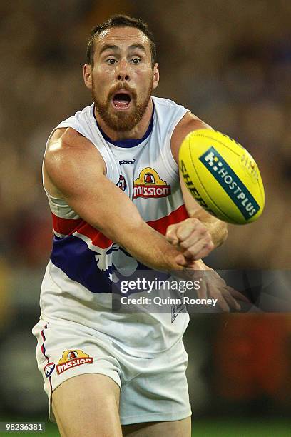 Ben Hudson of the Bulldogs handballs during the round two AFL match between the Richmond Tigers and the Western Bulldogs at the Melbourne Cricket...