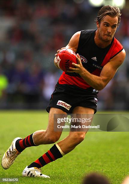 Andrew Welsh of the Bombers gathers the ball during the round two AFL match between the Essendon Bombers and the Fremantle Dockers at Etihad Stadium...