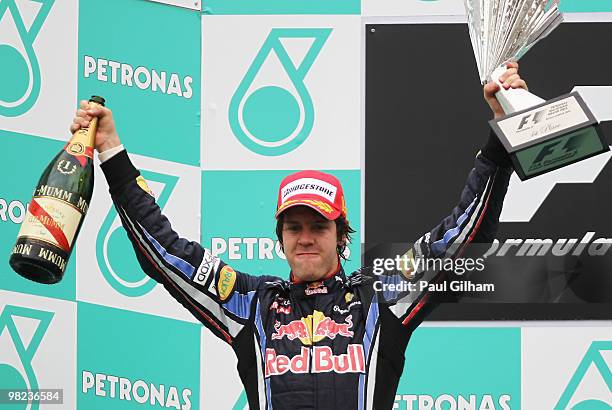 Sebastian Vettel of Germany and Red Bull Racing celebrates on the podium after winning the Malaysian Formula One Grand Prix at the Sepang Circuit on...