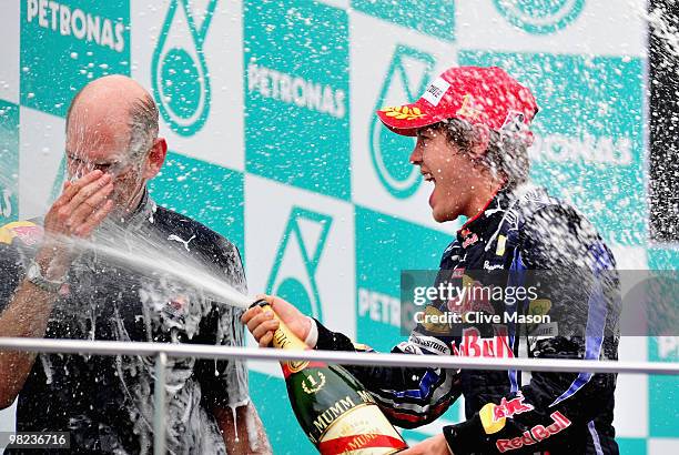 Sebastian Vettel of Germany and Red Bull Racing celebrates on the podium with Red Bull Racing Chief Technical Officer Adrian Newey after winning the...