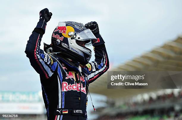 Sebastian Vettel of Germany and Red Bull Racing celebrates in parc ferme after winning the Malaysian Formula One Grand Prix at the Sepang Circuit on...