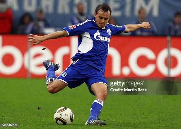 Rafinha of Schalke runs with the ball during the Bundesliga match between FC Schalke 04 and FC Bayern Muenchen at the Veltins Arena April 3, 2010 in...