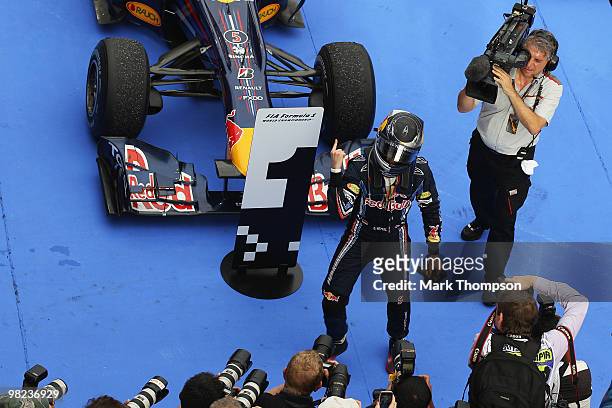 Sebastian Vettel of Germany and Red Bull Racing celebrates with team mates in parc ferme after winning the Malaysian Formula One Grand Prix at the...