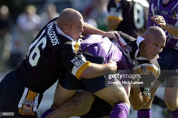 Corey Pearson and Tyran Smith of the West Tigers combine to thwart the Melbourne Storm during the Round 5 NRL Match between the West Tigers and the...