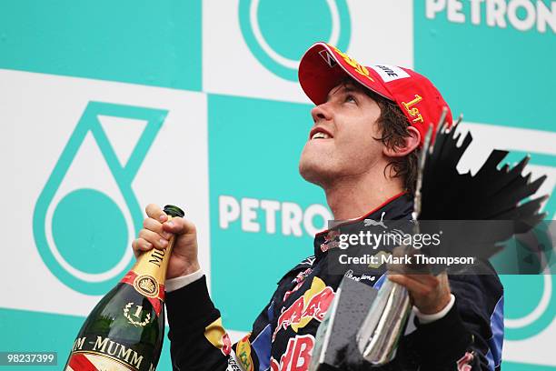 Sebastian Vettel of Germany and Red Bull Racing celebrates on the podium after winning the Malaysian Formula One Grand Prix at the Sepang Circuit on...