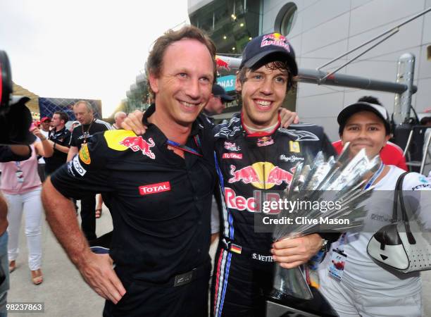 Sebastian Vettel of Germany and Red Bull Racing celebrates with his Team Principal Christian Horner after winning the Malaysian Formula One Grand...