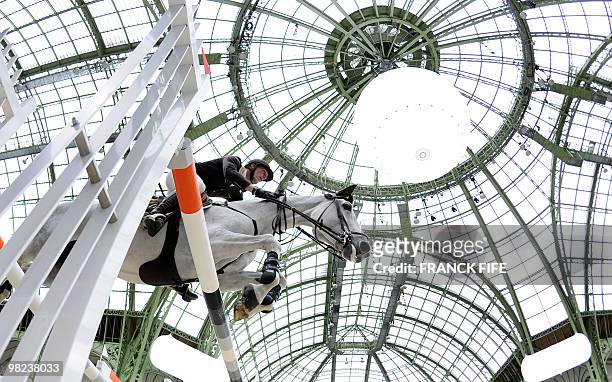 France's Kevin Staut rides his Sea Coast Silvana as he performs on April 4 at The Grand Palais in Paris during the International Jumping Competition....
