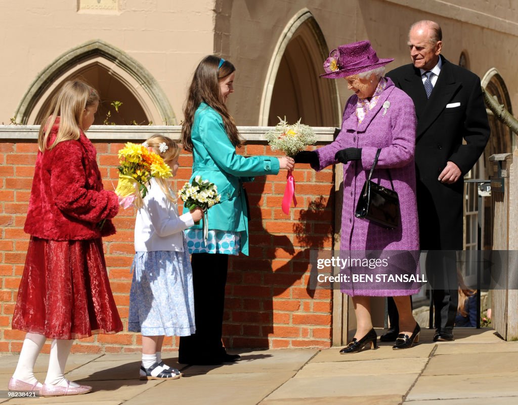 Children give flowers to Britain's Queen