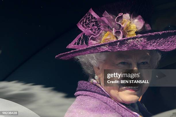 Britain's Queen Elizabeth II holds flowers as she leaves an Easter Sunday church service in Windsor on April 4, 2019. AFP PHOTO / BEN STANSALL / WPA...