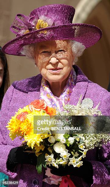 Britain's Queen Elizabeth II holds flowers as she leaves an Easter Sunday church service in Windsor on April 4, 2019. AFP PHOTO / BEN STANSALL / WPA...