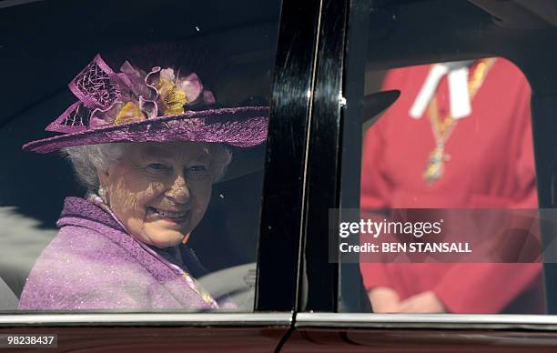 Britain's Queen Elizabeth II holds flowers as she leaves an Easter Sunday church service in Windsor on April 4, 2019. AFP PHOTO / BEN STANSALL / WPA...