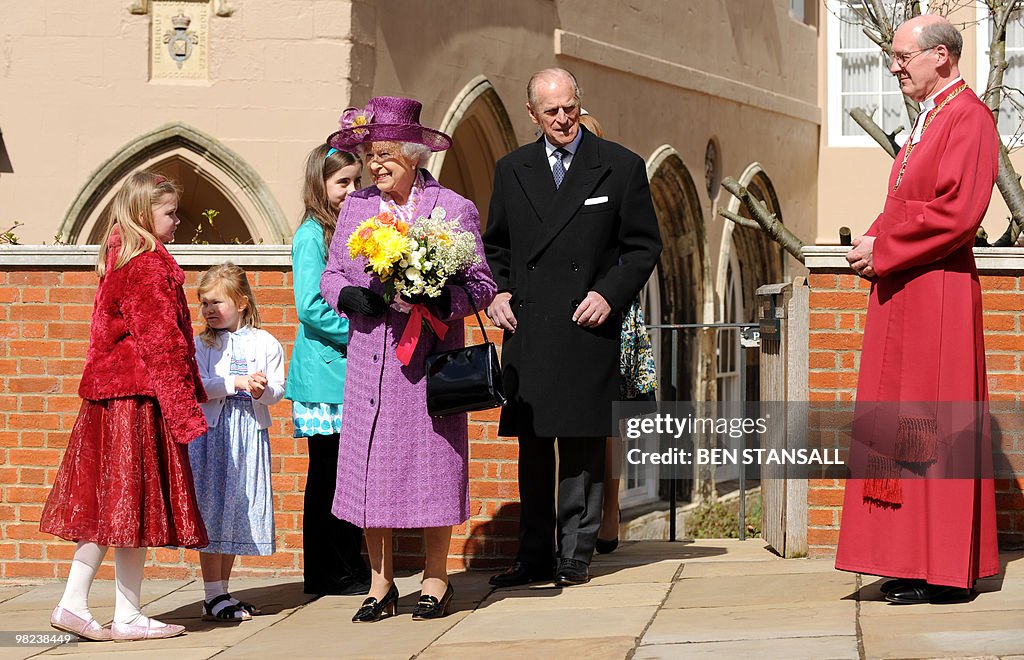Children give flowers to Britain's Queen