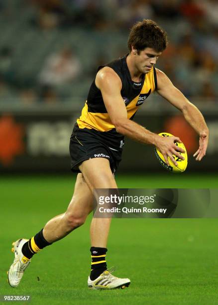 Trent Cotchin of the Tigers kicks during the round two AFL match between the Richmond Tigers and the Western Bulldogs at the Melbourne Cricket Ground...