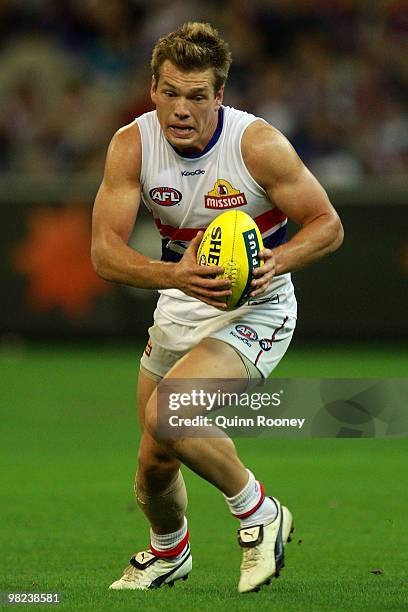 Shaun Higgins of the Bulldogs runs with the ball during the round two AFL match between the Richmond Tigers and the Western Bulldogs at the Melbourne...