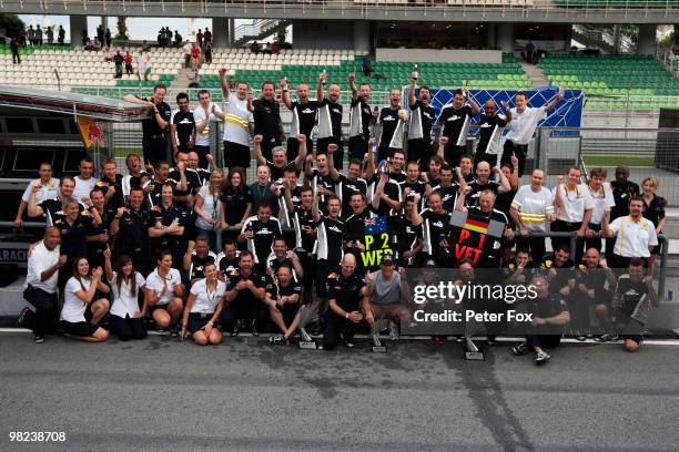 Sebastian Vettel of Germany and Red Bull Racing celebrates with his team mates in the paddock after winning the Malaysian Formula One Grand Prix at...