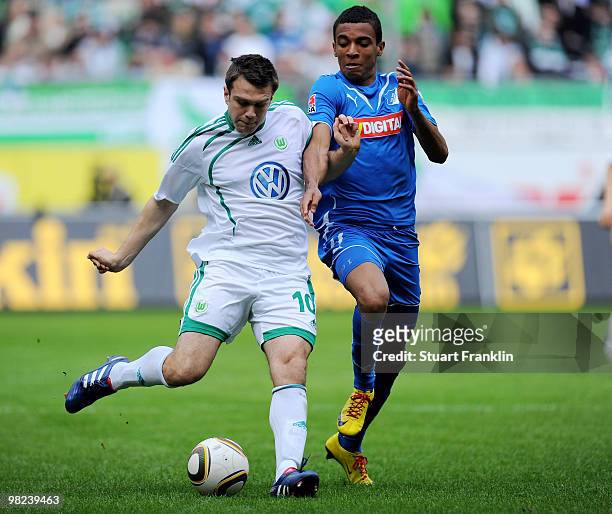 Zvjezdan Misimovic of Wolfsburg is challenged by Luiz Gustavo of Hoffenheim during the Bundesliga match between VfL Wolfsburg and 1899 Hoffenheim at...