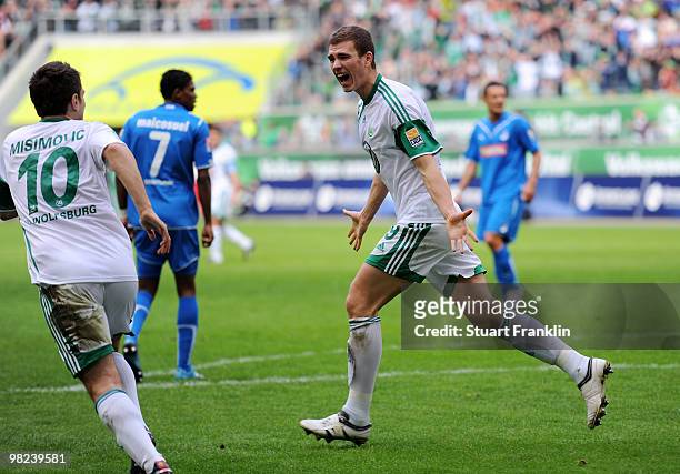 Edin Dzeko of Wolfsburg celebrates scoring his team's first goal with Zvjezdan Misimovic during the Bundesliga match between VfL Wolfsburg and 1899...