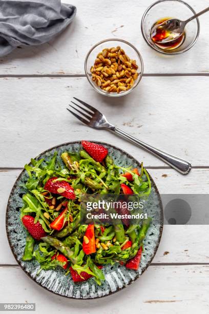 salad of green asparagus, rocket, strawberries and pine nuts - vinaigrette dressing stock pictures, royalty-free photos & images