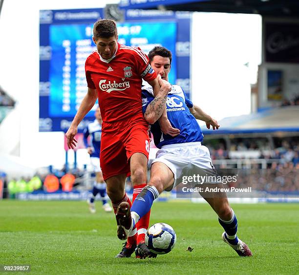 Steven Gerrard of Liverpool competes with Liam Ridgewell of Birmingham during the Barclays Premier League match between Birmingham City and Liverpool...