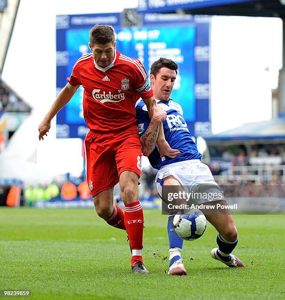 Steven Gerrard of Liverpool competes with Liam Ridgewell of Birmingham during the Barclays Premier League match between Birmingham City and Liverpool...